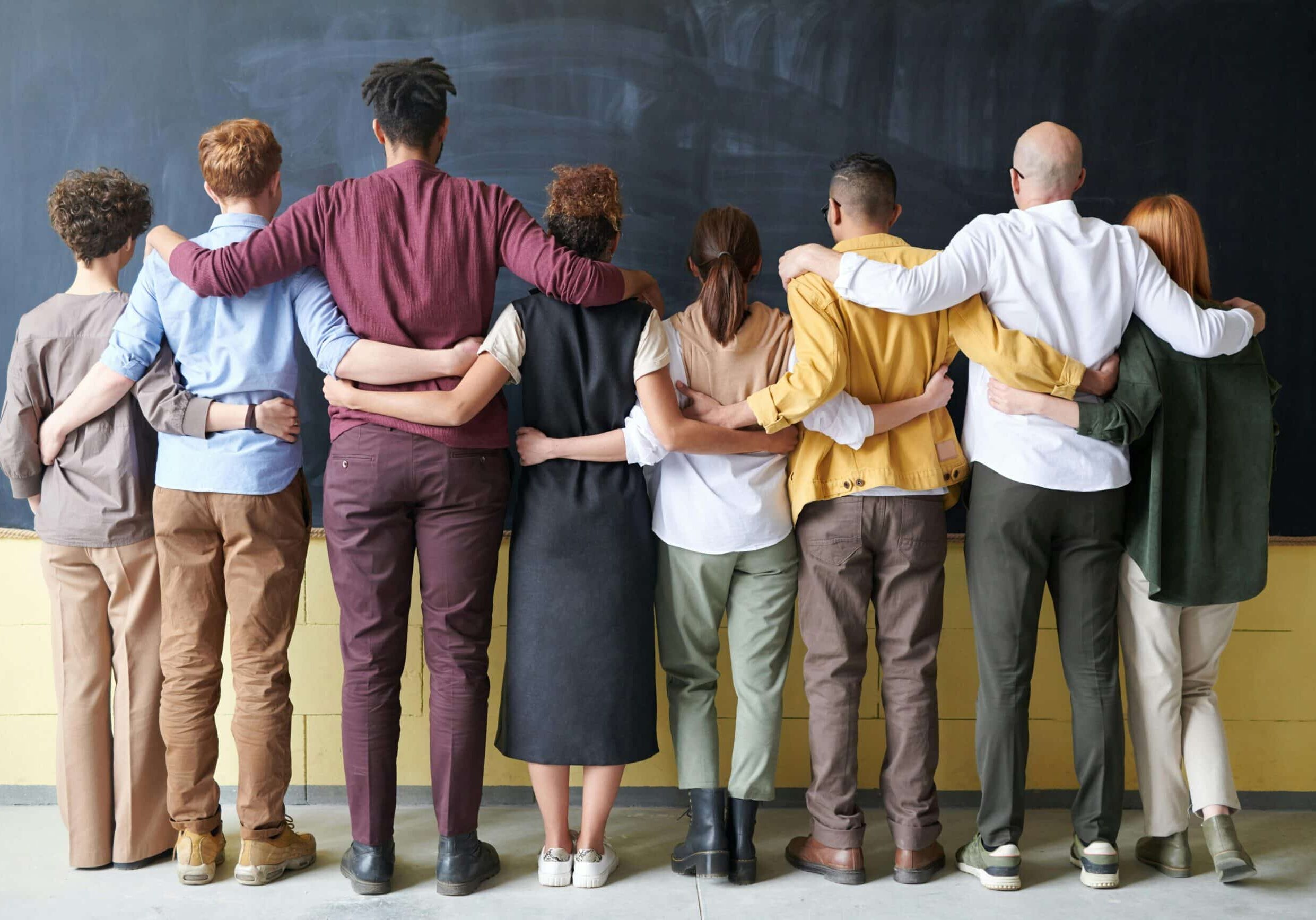 group-of-people-with-hands-onback
