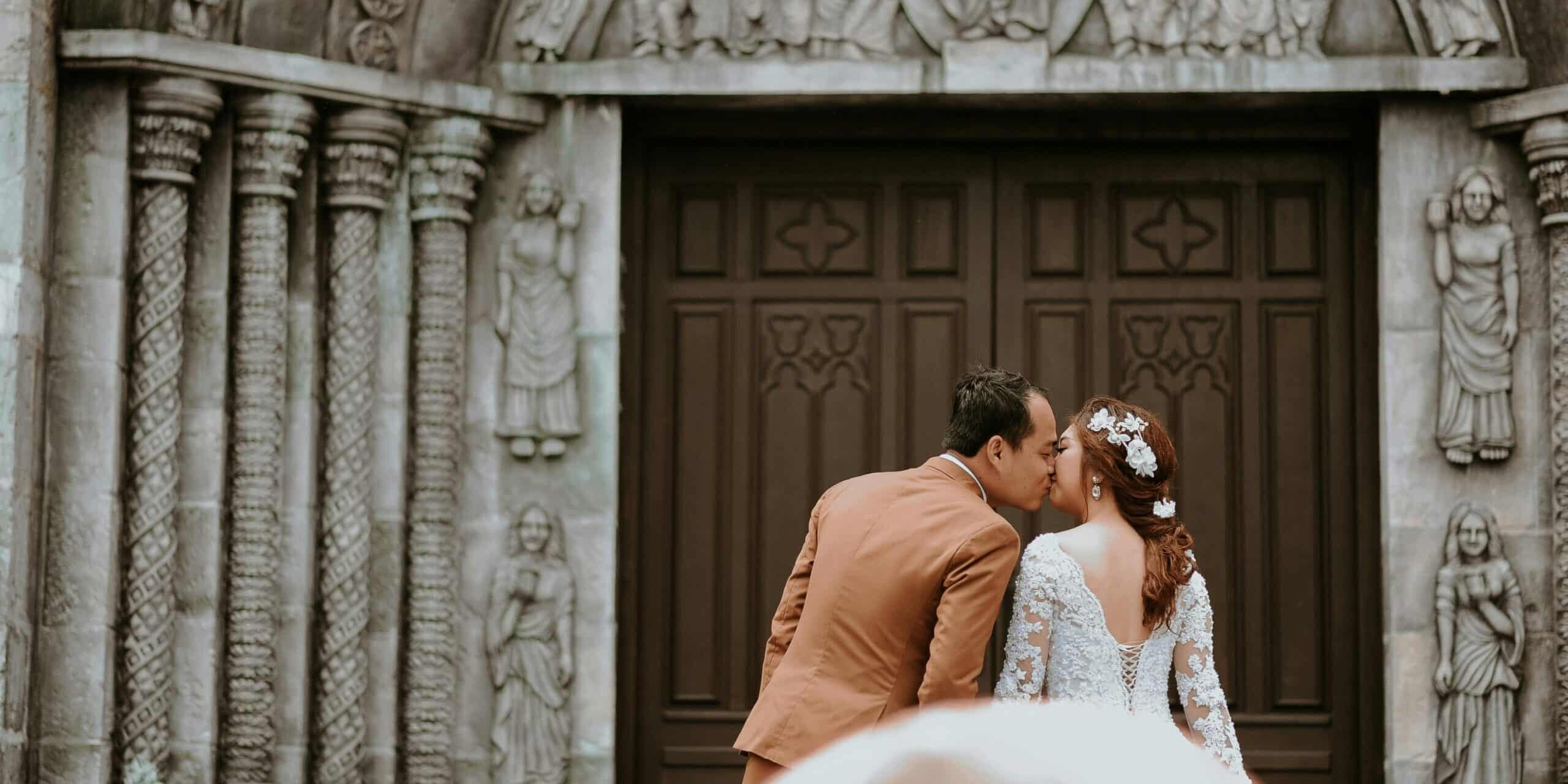 married-couple-infront-of-church-doors